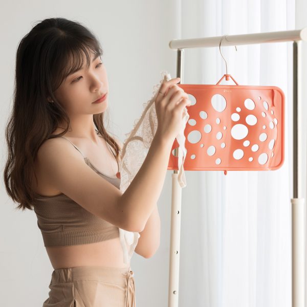 Joyce Lai standing next to her Bras Up hanger