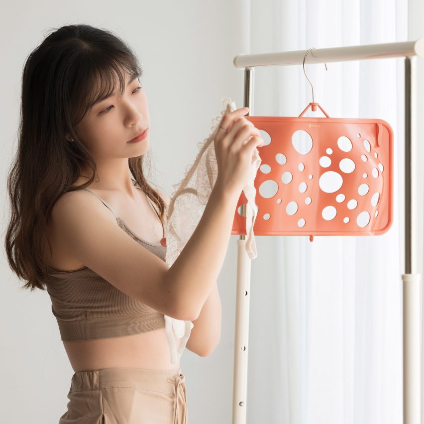 Joyce Lai standing next to her Bras Up hanger