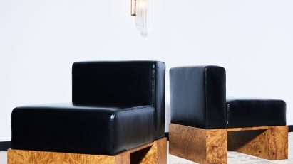 Photo of black leather chairs with wooden legs