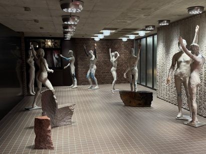 life-size statues of humans in a foyer