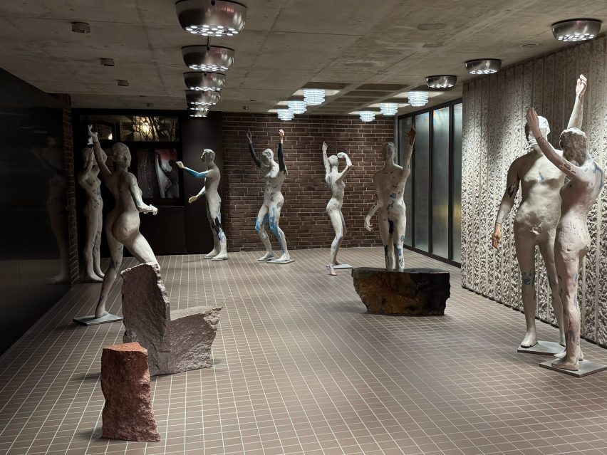 life-size statues of humans in a foyer