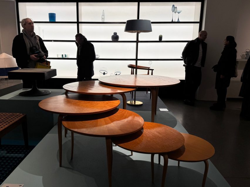 Cascading set of side tables infront of shelving unit