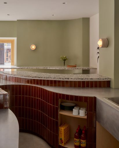 Deep red tiles covering the front of a rounded service counter