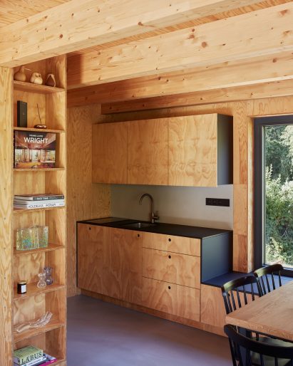 Wood-lined interior of Skylight Hut by Atelier Hajný