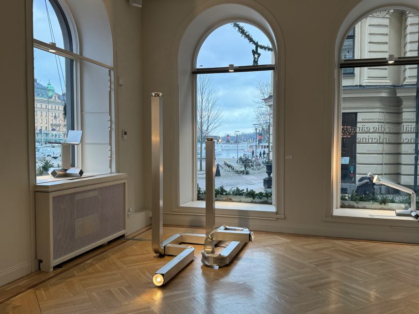 Gallery sapce with large windows and design object in a corner