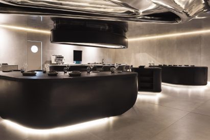 Sculptural black elements topped with counters carved from volcanic stone