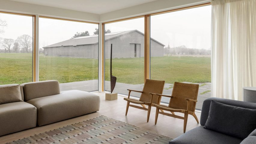 Living room with corner windows overlooking a barn