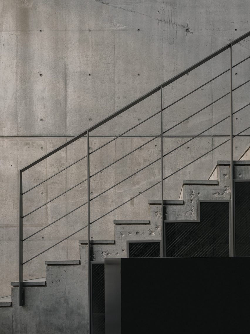 Geometric concrete staircase with simple steel railings