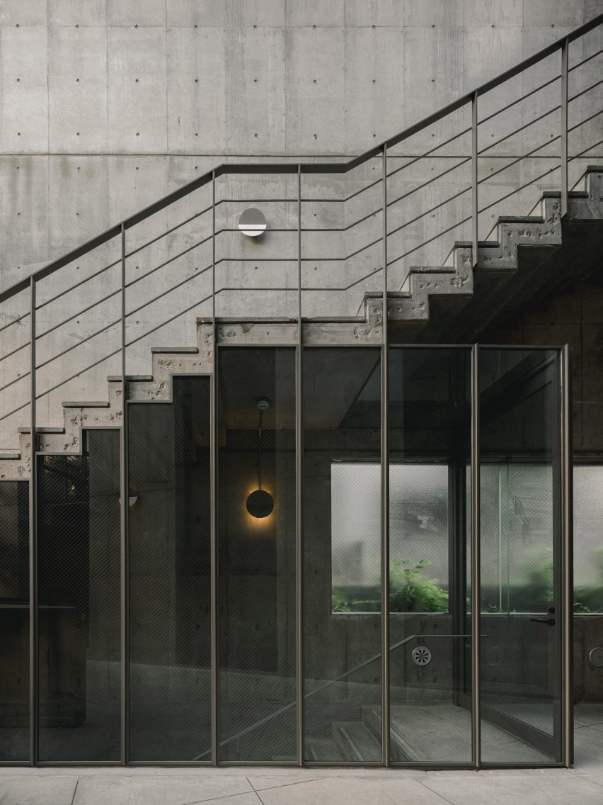 Concrete staircase with steel railings and glass panelling