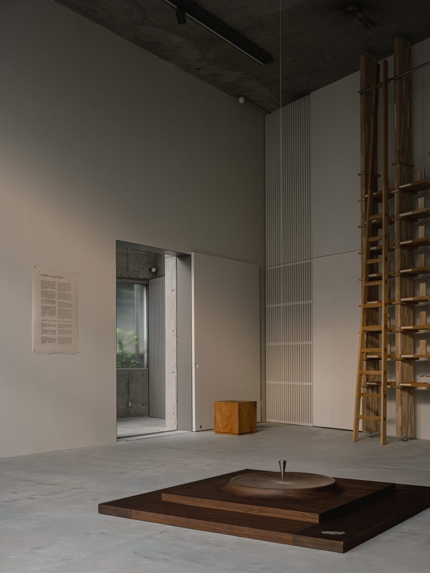 Gallery space with wooden exhibition pieces