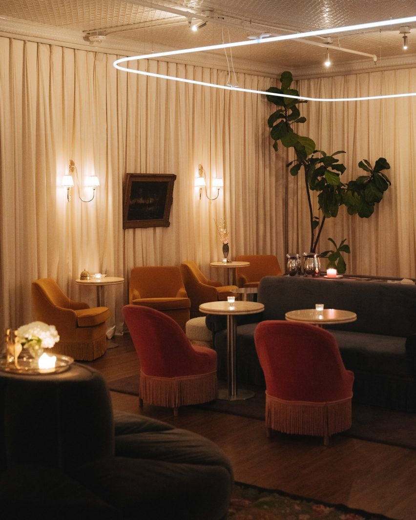 Dimly lit bar lounge area with illuminated wall sconces
