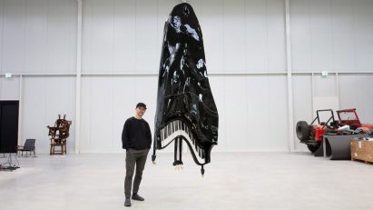 Maarten Baas in front of hanging piano