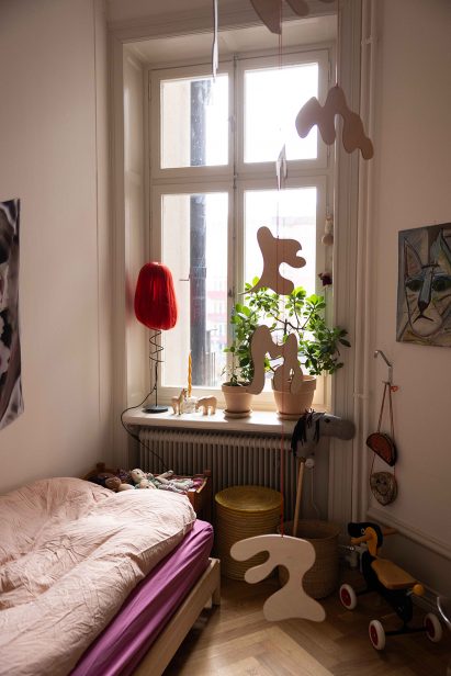 Wooden mobiles and lamp with red wig