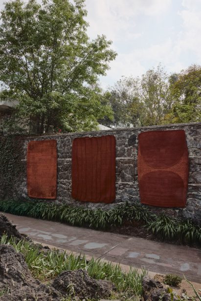 Rugs on lava stone wall