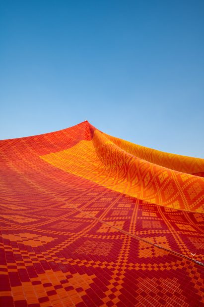 Close-up of woven mats with traditional Thai patterns