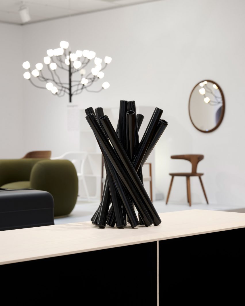 Black tubular vase in museum exhibition