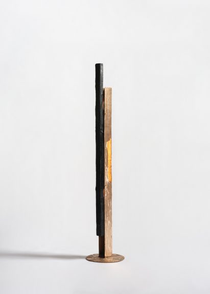 Studio photo of a tall lamp made from a long, rectangular piece of copper
