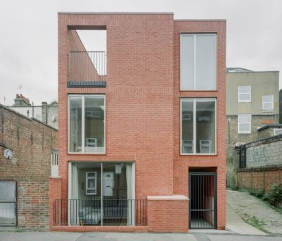 Exterior view of redbrick townhouse by Nikjoo
