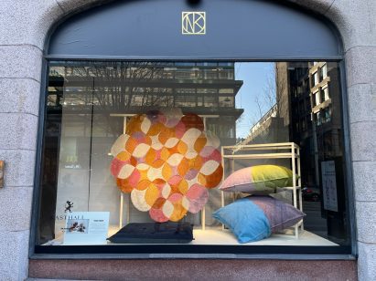 Shop window showing colourful rug