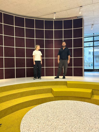 Two people standing above a chartreuse conversation pit