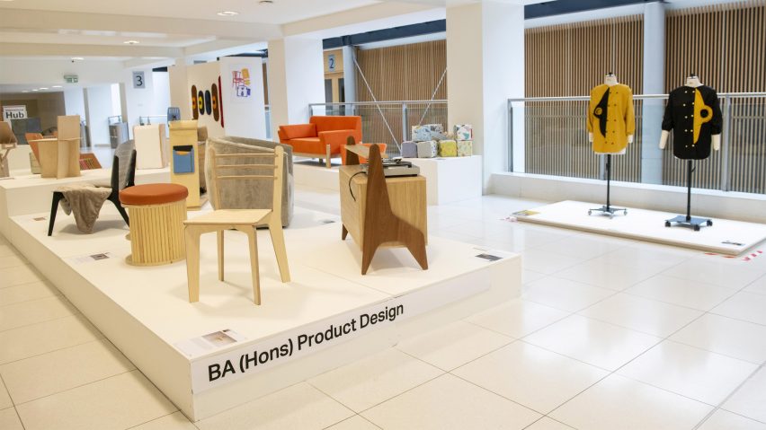 A photograph of a student exhibition in tones of beige and white.