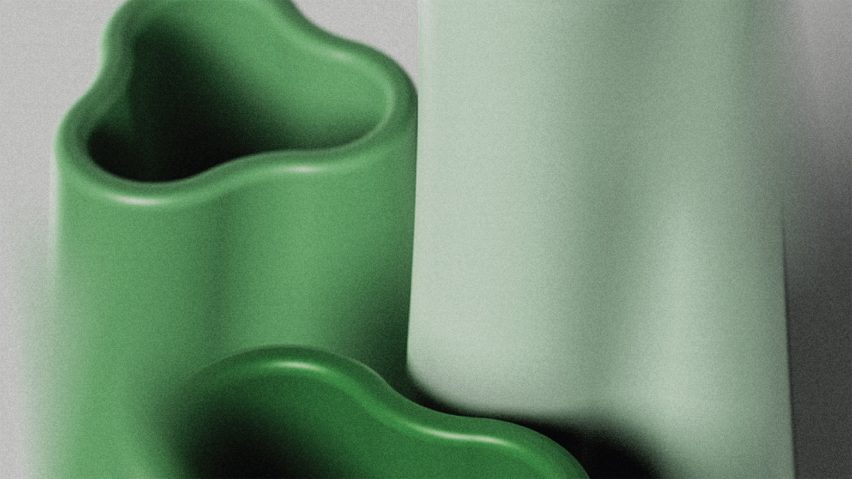 A close up photograph of three vases in a curved, abstract shape, in tones of green.