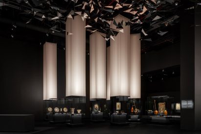 OMA exhibition design with illuminated fabric pillars