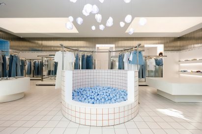 A circular pit filled with pale blue balls in the centre of a store