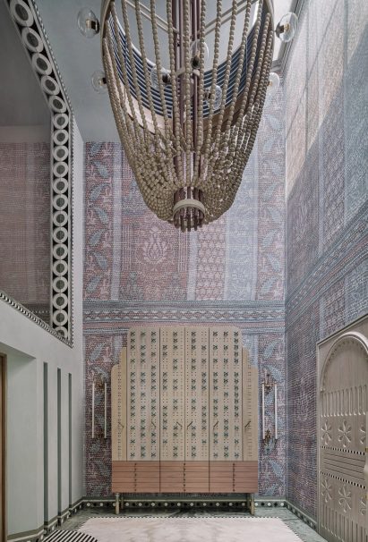 Large chandelier in hallway with purple walls
