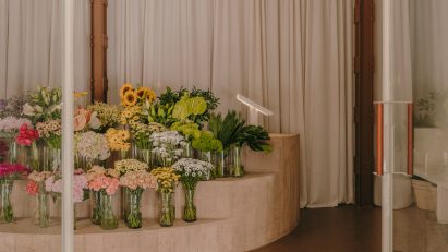 Flower shop interior with concrete display stand holding flowers