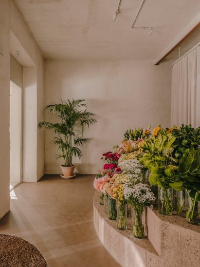 Flower shop interior with concrete display stand holding flowers