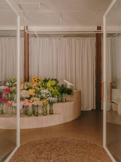 Flower shop interior with concrete display stand holding flowers