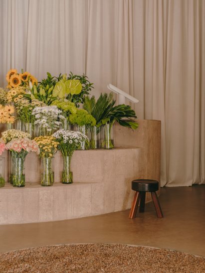 Flower shop interior with concrete display stand holding flowers