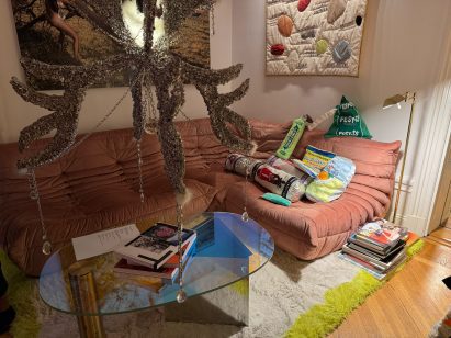Busy living room with chandelier and sofa