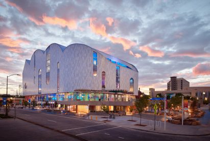 La Nube at night with lights on the aluminium facade