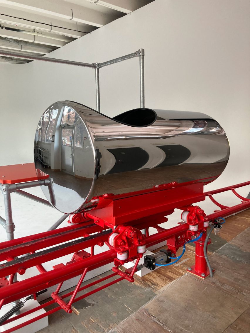 chrome rollercoaster cabin on red tracks