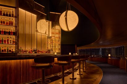 Illuminated bar area with curved counter and cushioned stools