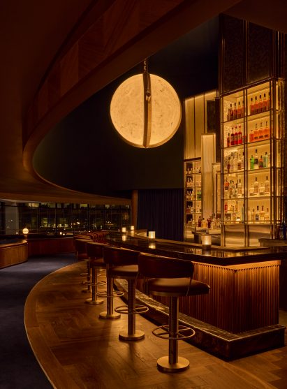 Bar with glowing displays and a large globe-shaped pendant light