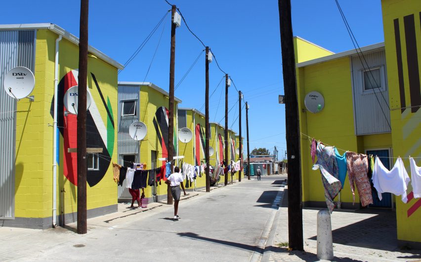 Photo of a developed street with colourful row housing in the Cape Town township of Khayelitsha