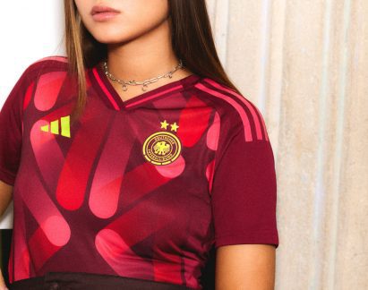Football shirt decorated with pattern in shades of red and pink