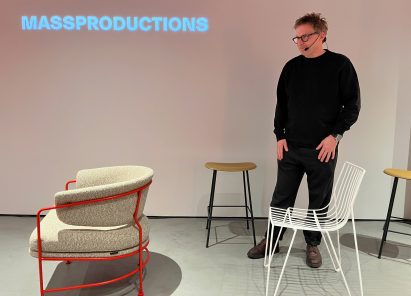 Armchair facing away from a standing man looking at it