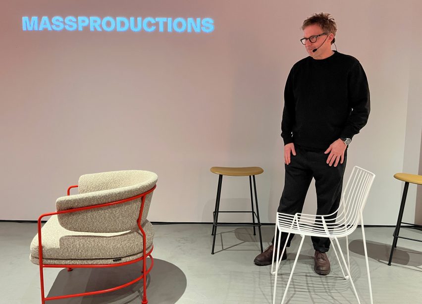Armchair facing away from a standing man looking at it