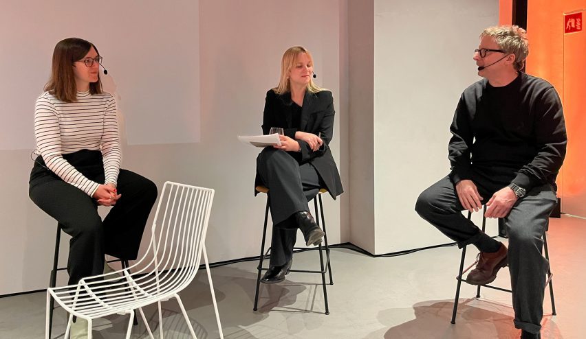 Three people sat on high stools