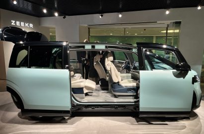 Concept car with doors open on display under spotlights