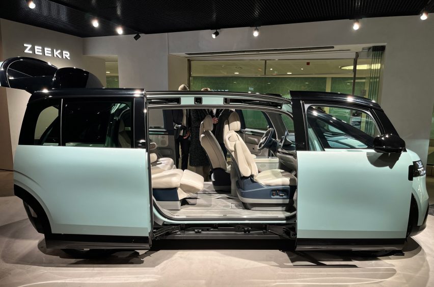 Concept car with doors open on display under spotlights