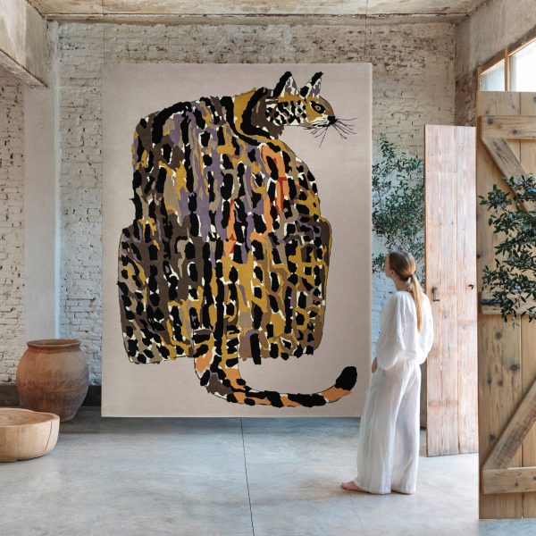 Photo of person looking at cat tapestry