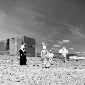 Photo of people in masks on a beach