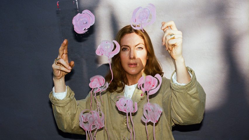 Photo of Faye Toogood holding up sheet with pink floral design