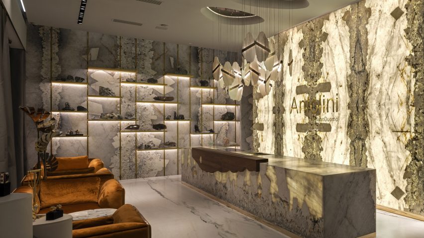A photograph of a room with marble walls and floors in tones of beige