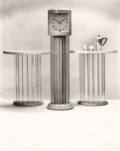 Betty Joel longcase clock in sycamore and glass, with a pair of console tables, silverware unknown, c 1937